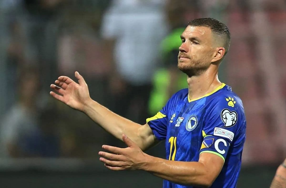 Edin Dzeko applauding the crowd in the Bosnia and Herzegovina shirt, wearing the captain's armband